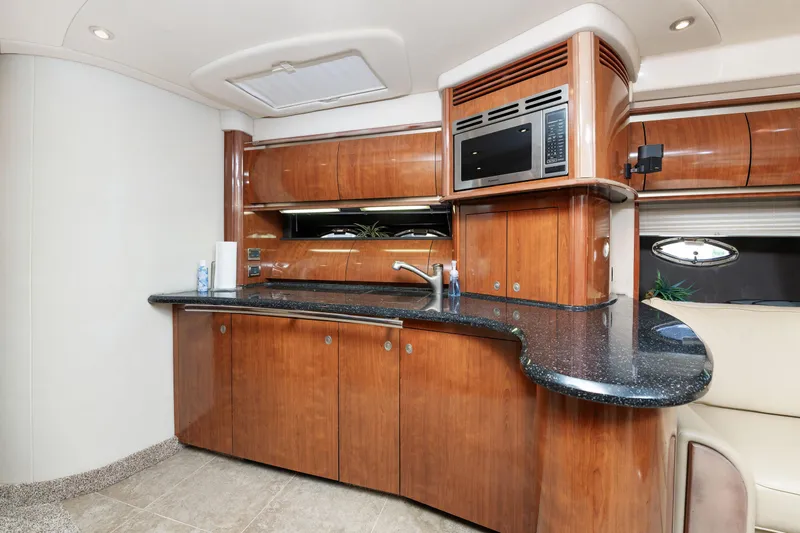 Jo's Diamond Yacht Photos Pics Luxurious 2004 Sea Ray 500 Sundancer yacht kitchen with wood cabinetry and modern appliances.