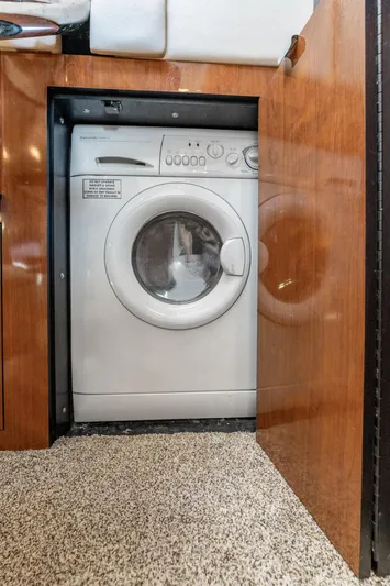 Jo's Diamond Yacht Photos Pics Washing machine inside 2004 Sea Ray 500 Sundancer yacht, wooden cabinet, carpeted floor.
