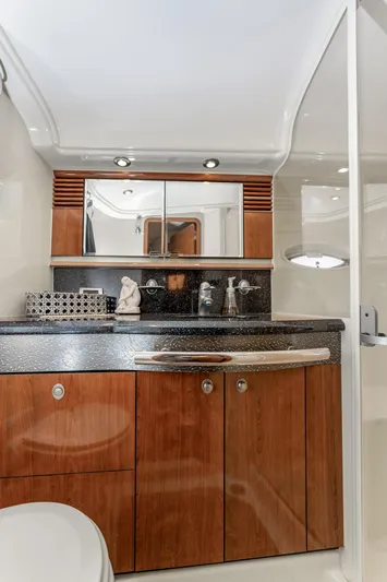 Jo's Diamond Yacht Photos Pics Luxurious bathroom in 2004 Sea Ray 500 Sundancer yacht with wood cabinetry and modern fixtures.