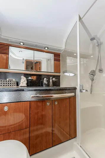 Jo's Diamond Yacht Photos Pics Luxurious bathroom in 2004 Sea Ray 500 Sundancer yacht with wood cabinetry and modern shower.