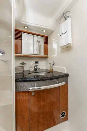 Jo's Diamond Yacht Photos Pics Luxurious bathroom in 2004 Sea Ray 500 Sundancer yacht with wood cabinetry and modern fixtures.
