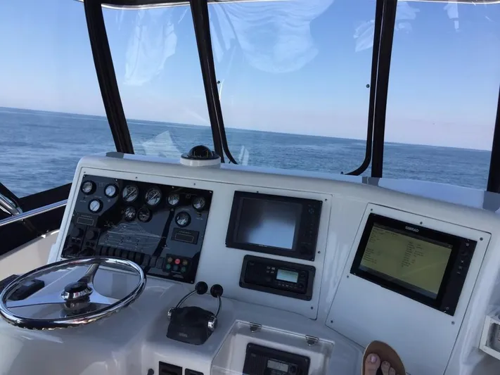 Mai Time Yacht Photos Pics Helm of 2001 Bertram 390 Convertible yacht with ocean view.