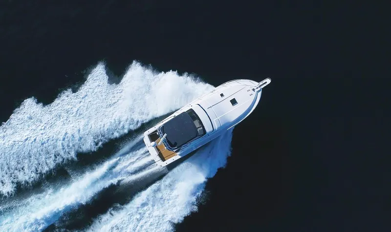 Mai Time Yacht Photos Pics 2001 Bertram 390 Convertible yacht cruising on open water, aerial view.