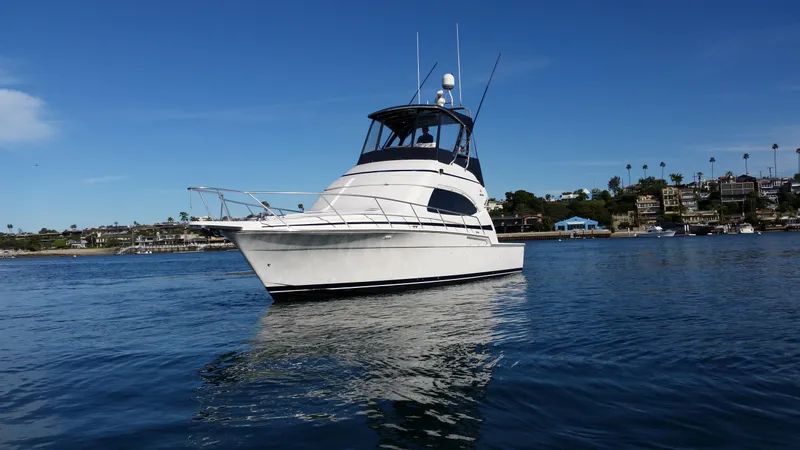 Mai Time Yacht Photos Pics 2001 Bertram 390 Convertible yacht on calm water under clear blue sky.