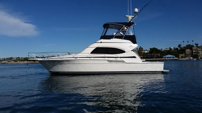 Mai Time Yacht Photos Pics 2001 Bertram 390 Convertible yacht on calm water under clear blue sky.