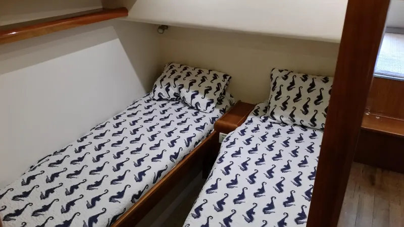 Mai Time Yacht Photos Pics Twin beds with seahorse-patterned bedding in a 2001 Bertram 390 Convertible cabin.