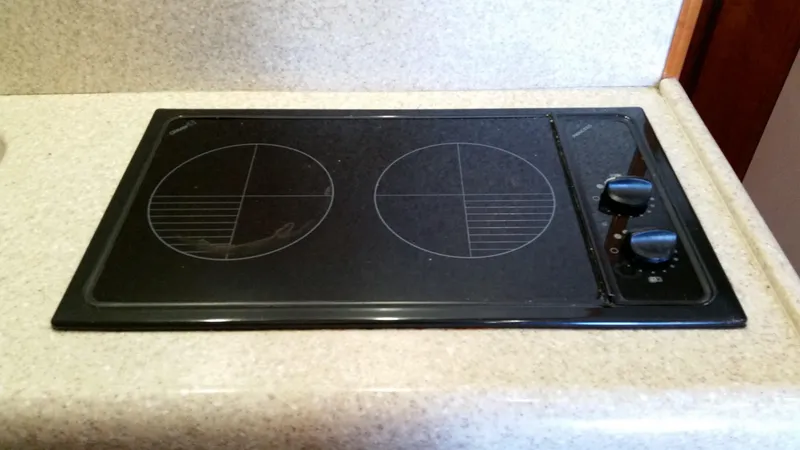 Mai Time Yacht Photos Pics Stovetop on 2001 Bertram 390 Convertible yacht, featuring dual burners and control knobs.