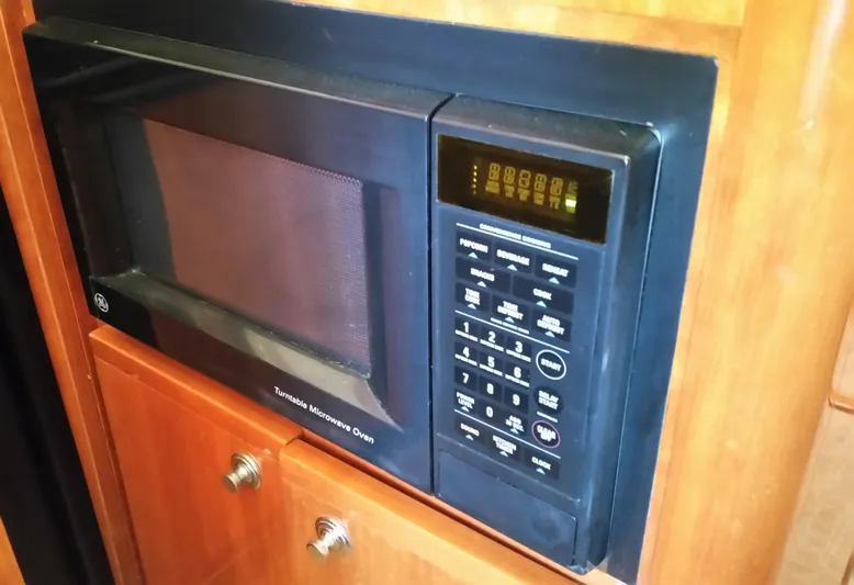 Mai Time Yacht Photos Pics Built-in microwave oven in a 2001 Bertram 390 Convertible yacht kitchen.