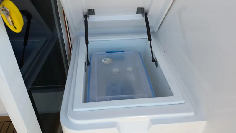 Mai Time Yacht Photos Pics Storage compartment on a 2001 Bertram 390 Convertible boat, featuring a clear container.