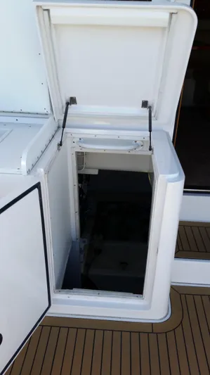 Mai Time Yacht Photos Pics Open hatch on 2001 Bertram 390 Convertible yacht, revealing interior compartment.