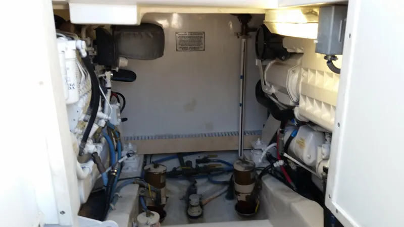 Mai Time Yacht Photos Pics Engine room of a 2001 Bertram 390 Convertible boat, showcasing mechanical components.