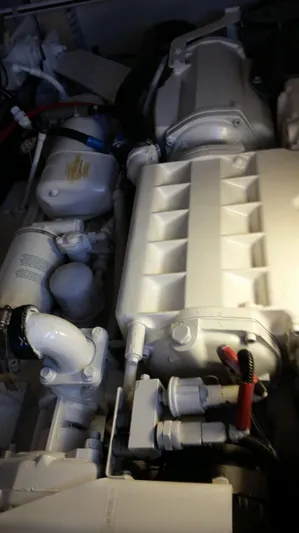 Mai Time Yacht Photos Pics Engine compartment of a 2001 Bertram 390 Convertible boat, showcasing mechanical components.