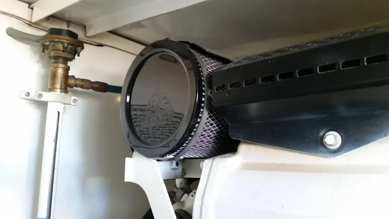 Mai Time Yacht Photos Pics Engine compartment of a 2001 Bertram 390 Convertible boat, featuring a filter and valve.