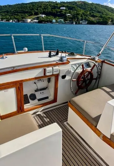 Padre Pio Yacht Photos Pics 1986 Grand Banks 42 Classic yacht helm with wooden accents and scenic ocean view.