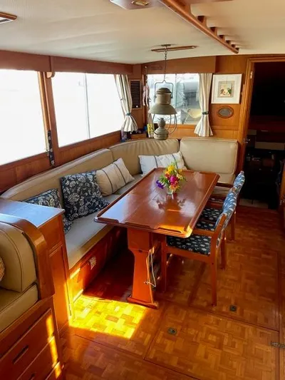 Padre Pio Yacht Photos Pics Interior of a 1986 Grand Banks 42 Classic yacht with elegant wood finish and cozy seating area.