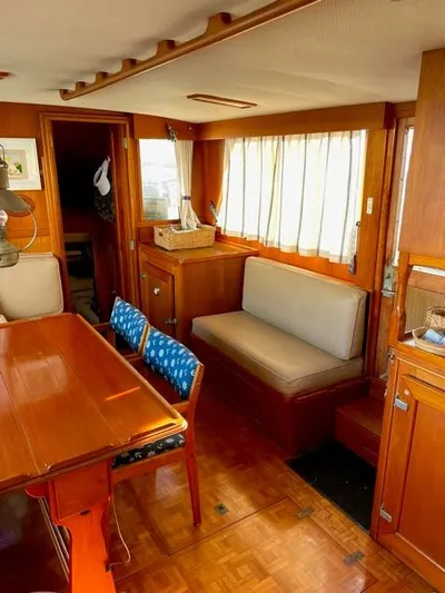 Padre Pio Yacht Photos Pics 1986 Grand Banks 42 Classic interior with wooden furnishings and cozy seating area.