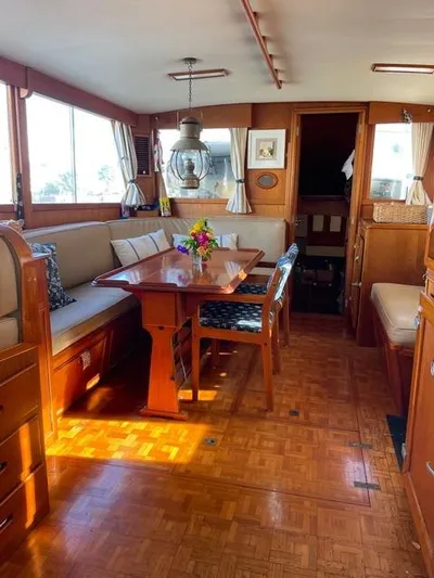 Padre Pio Yacht Photos Pics Interior of 1986 Grand Banks 42 Classic yacht with elegant wood furnishings and dining area.