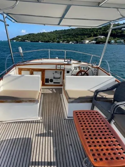 Padre Pio Yacht Photos Pics 1986 Grand Banks 42 Classic yacht interior with seating, steering wheel, and ocean view.