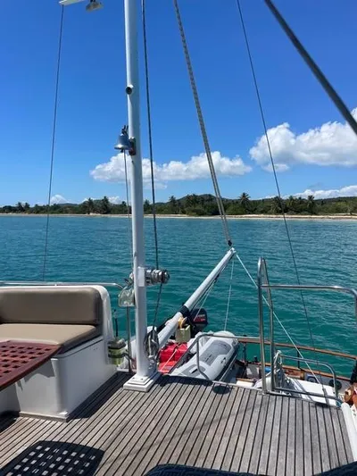Padre Pio Yacht Photos Pics 1986 Grand Banks 42 Classic yacht on serene blue water with clear sky and distant shoreline.