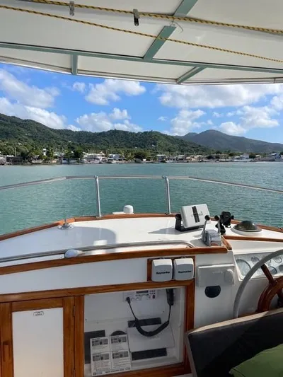 Padre Pio Yacht Photos Pics 1986 Grand Banks 42 Classic yacht with scenic coastal view and mountains in the background.