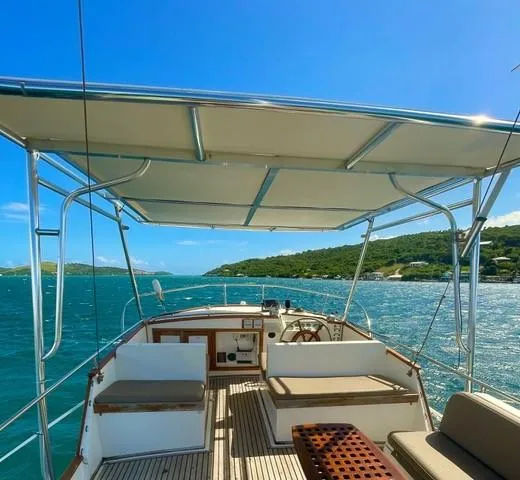 Padre Pio Yacht Photos Pics 1986 Grand Banks 42 Classic yacht interior with seating, canopy, and scenic ocean view.