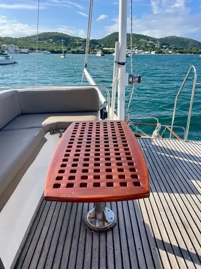 Padre Pio Yacht Photos Pics 1986 Grand Banks 42 Classic yacht deck with wooden table, scenic ocean view.