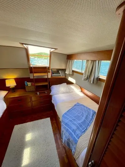 Padre Pio Yacht Photos Pics Cozy bedroom in 1986 Grand Banks 42 Classic yacht with wooden interior and ocean view.