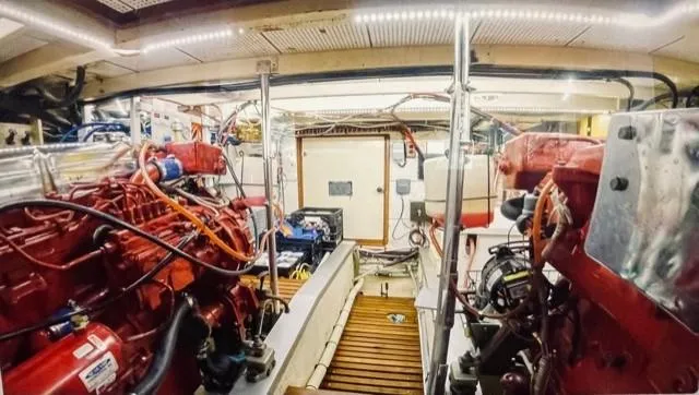 Padre Pio Yacht Photos Pics Engine room of 1986 Grand Banks 42 Classic yacht, featuring dual red engines and organized wiring.