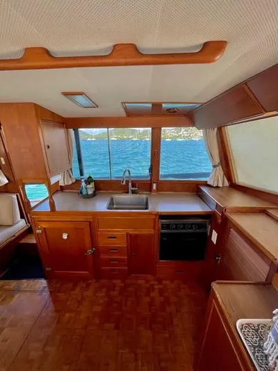 Padre Pio Yacht Photos Pics Interior of 1986 Grand Banks 42 Classic yacht with wooden cabinetry and ocean view.