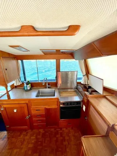 Padre Pio Yacht Photos Pics 1986 Grand Banks 42 Classic yacht kitchen with wooden cabinetry and ocean view.