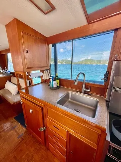 Padre Pio Yacht Photos Pics 1986 Grand Banks 42 Classic yacht interior with wooden cabinetry and ocean view.