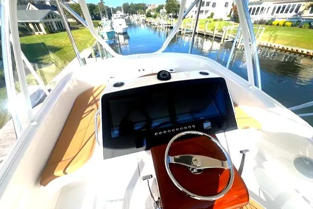  Yacht Photos Pics 2024 Custom Carolina Albemarle Spencer boat helm with scenic marina view.