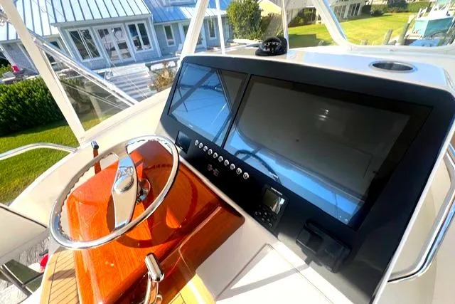  Yacht Photos Pics 2024 Custom Carolina Albemarle Spencer boat dashboard with modern controls and wooden steering wheel.