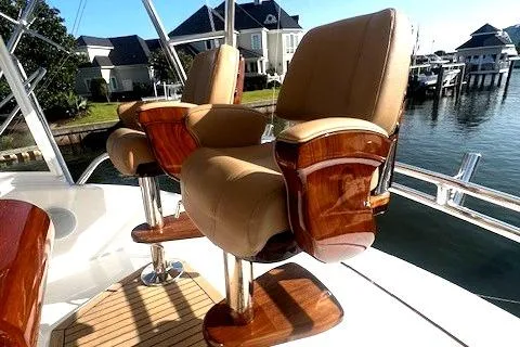  Yacht Photos Pics Luxurious seating on 2024 Custom Carolina Albemarle Spencer yacht, docked by waterfront homes.