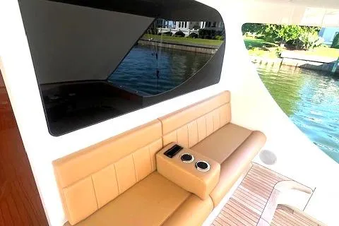  Yacht Photos Pics 2024 Custom Carolina Albemarle Spencer yacht with tan seating and cup holders, docked by water.