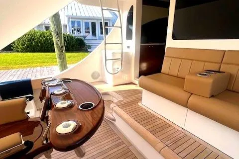  Yacht Photos Pics Luxurious 2024 Custom Carolina Albemarle Spencer yacht interior with elegant seating and wooden accents.