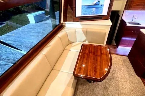  Yacht Photos Pics Luxurious 2024 Custom Carolina Albemarle Spencer yacht interior with elegant seating and wooden table.