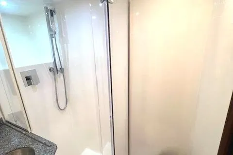  Yacht Photos Pics 2024 Custom Carolina Albemarle Spencer yacht bathroom with modern shower and sleek design.