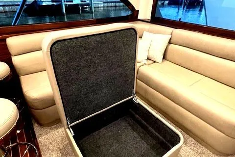  Yacht Photos Pics Luxurious 2024 Custom Carolina Albemarle Spencer yacht interior with beige seating and storage.