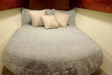  Yacht Photos Pics 2024 Custom Carolina Albemarle Spencer boat cabin with cozy bed and pillows.