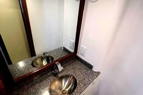  Yacht Photos Pics 2024 Custom Carolina Albemarle Spencer bathroom with granite countertop and modern sink.