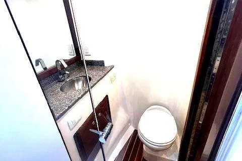  Yacht Photos Pics 2024 Custom Carolina Albemarle Spencer yacht bathroom with granite countertop and modern fixtures.