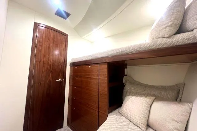  Yacht Photos Pics 2024 Custom Carolina Albemarle Spencer yacht cabin with wooden door and cozy bunk beds.