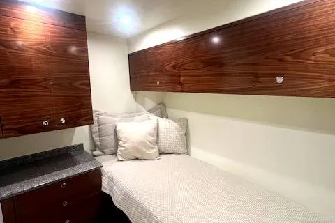  Yacht Photos Pics 2024 Custom Carolina Albemarle Spencer cabin with wooden cabinets and cozy bed.