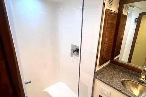  Yacht Photos Pics 2024 Custom Carolina Albemarle Spencer yacht bathroom with modern shower and granite countertop.