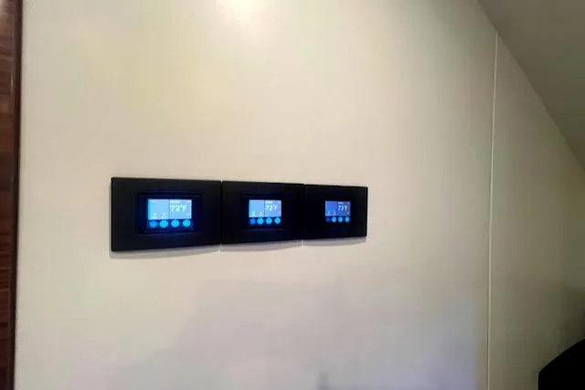  Yacht Photos Pics Three digital thermostats on a wall in a 2024 Custom Carolina Albemarle Spencer.