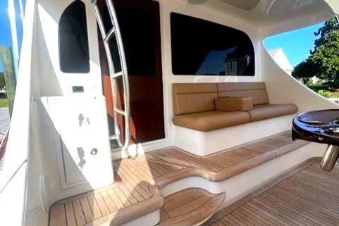  Yacht Photos Pics 2024 Custom Carolina Albemarle Spencer yacht interior with seating and wooden flooring.
