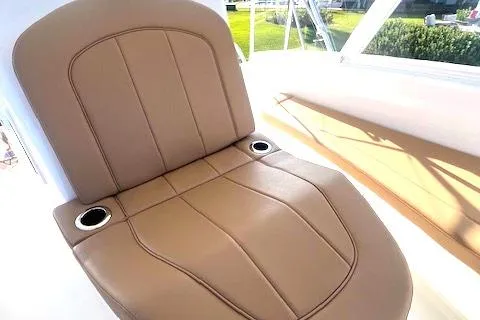  Yacht Photos Pics 2024 Custom Carolina Albemarle Spencer boat seat with tan leather upholstery and cup holders.