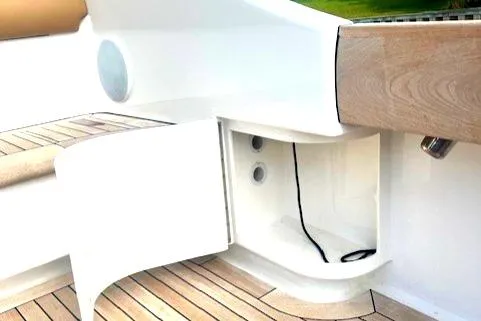  Yacht Photos Pics 2024 Custom Carolina Albemarle Spencer boat interior with open storage compartment and wood accents.