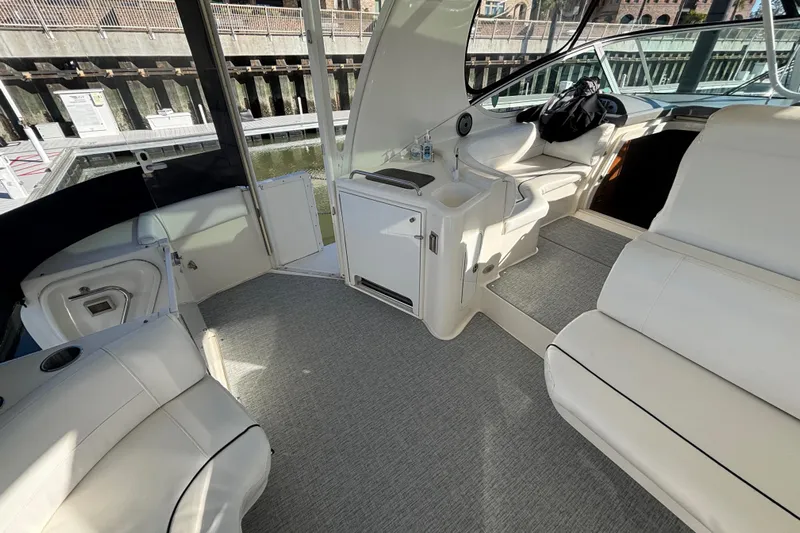 Liberty Call Yacht Photos Pics 2005 Cruisers Yachts 455 Express Motoryacht aft deck area with Wet Bar, Beverage Refrigerator, comfortable seating and new Grassmat snap-in flooring